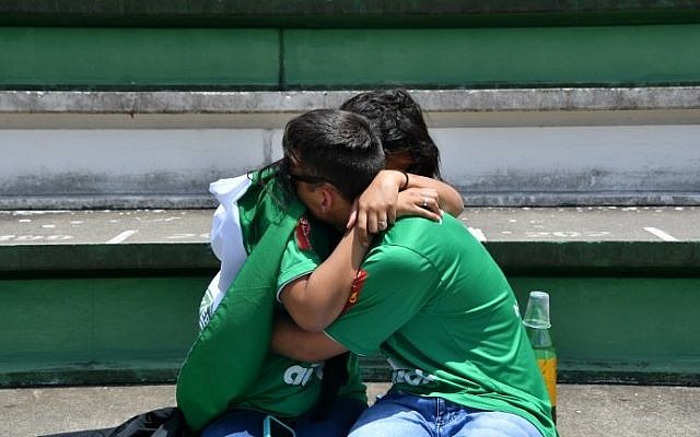 People cry during a tribute to the players of Brazilian team Chapecoense Real who were killed in a plane accident in the Colombian mountains, at the club's Arena Conda stadium in Chapeco, in the southern Brazilian state of Santa Catarina, on November 29, 2016. (AFP PHOTO / Nelson ALMEIDA)