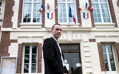 (FILES) This file photo taken on March 31, 2014 shows Cyril Nauth, newly elected mayor of Mantes-la-Ville for the French far-right Front National (FN) party, posing in front of the city hall of Mantes-la-Ville, some 50km west of Paris. (AFP PHOTO / FRED DUFOUR)