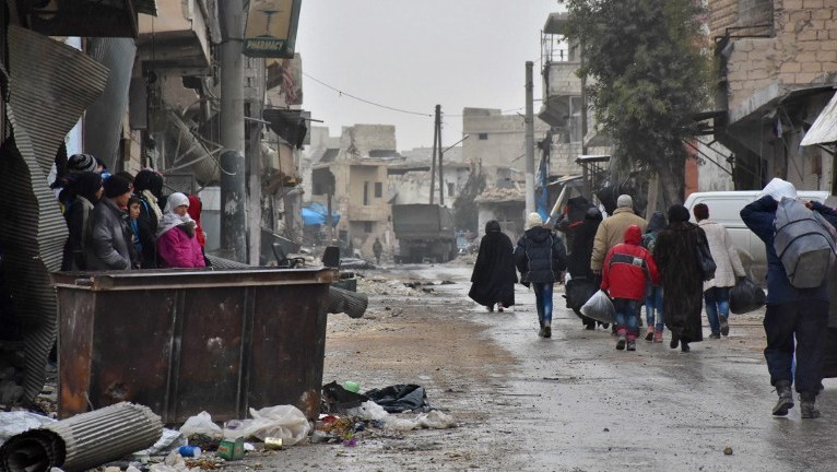 Syrian residents fleeing the eastern part of Aleppo walk through a street in Masaken Hanano, a former rebel-held district which was retaken by the regime forces last week, on November 30, 2016. (AFP Photo/George Ourfalian) Syrian residents fleeing the eastern part of Aleppo walk through a street in Masaken Hanano, a former rebel-held district which was retaken by the regime forces last week, on November 30, 2016. (AFP Photo/George Ourfalian)