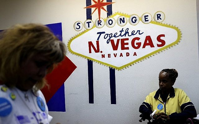  Volunteers look on as Democratic presidential nominee Hillary Clinton visits a campaign field office on November 2, 2016 in North Las Vegas, Nevada. (Justin Sullivan/Getty Images/AFP)