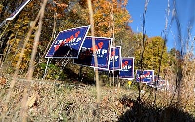 Dump Trump signs line a traffic circle on November 8, 2016 in North Manchester, New Hampshire. After a contentious campaign season, Americans go to the polls today to choose the next president of the United States. (Darren McCollester/Getty Images/AFP) 