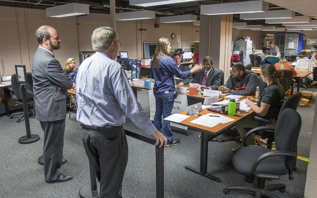 Karen Williams, center, presents a set of ballots to the Leon County Florida Canvassing Board that they will either accept or reject on November 8, 2016 in Tallahassee, Florida. (Mark Wallheiser/Getty Images/AFP)