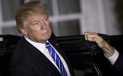President-elect Donald Trump listens to questions from the press as he gets into his car after a day of meetings at Trump International Golf Club, November 19, 2016, in Bedminster Township, New Jersey. (Drew Angerer/Getty Images/AFP)