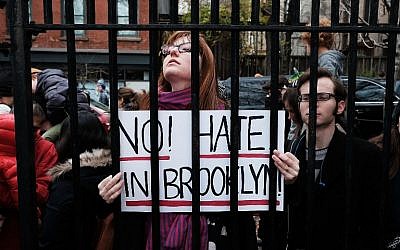 People participate in an anti-hate rally at a Brooklyn park named in memory of Beastie Boys band member Adam Yauch after it was defaced with swastikas on November 20, 2016 in New York City. (Spencer Platt/Getty Images/AFP)