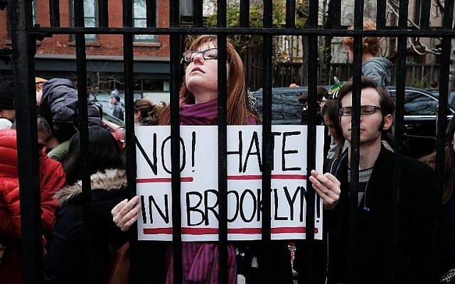 People participate in an anti-hate rally at a Brooklyn park named in memory of Beastie Boys band member Adam Yauch after it was defaced with swastikas on November 20, 2016 in New York City. (Spencer Platt/Getty Images/AFP) People participate in an anti-hate rally at a Brooklyn park named in memory of Beastie Boys band member Adam Yauch after it was defaced with swastikas on November 20, 2016 in New York City. (Spencer Platt/Getty Images/AFP)