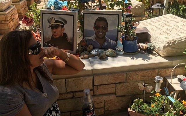 Irit Shahar at her son Omri's grave in Kfar Saba. (Courtesy)