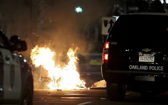 A trash fire burns during protests in Oakland, Calif., late Tuesday, Nov. 8, 2016. President-elect Donald Trumpâs victory set off multiple protests. (Anda Chu/Bay Area News Group via AP)