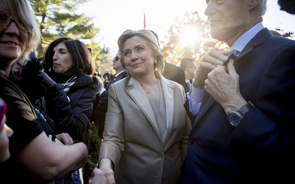 Hillary Clinton, accompanied by her husband, former President Bill Clinton, right, greets supporters outside Douglas G. Grafflin School in Chappaqua, N.Y., Tuesday, November 8, 2016, after voting. (AP/Andrew Harnik)