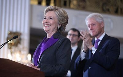 Former president Bill Clinton applauds as his wife, Democratic presidential candidate Hillary Clinton speaks in New York, Wednesday, Nov. 9, 2016. Clinton conceded the presidency to Donald Trump in a phone call early Wednesday morning.  (AP Photo/Andrew Harnik)