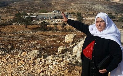 Mariam Hammad, of nearby Silwad, points to a piece of land in the West Bank she says belongs to her but was taken by Israelis to build the outpost of Amona, November 2016 (Raphael Ahren/Times of Israel)