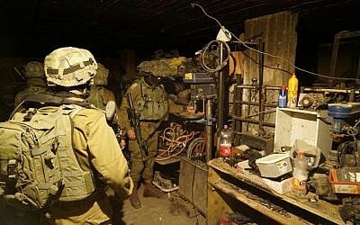 Israeli soldiers seize a drill press from a workshop allegedly used to manufacture illegal guns in the West Bank city of Jenin, early in the morning on November 8, 2016. (IDF Spokesperson's Unit)