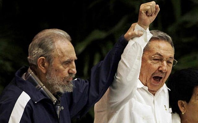 Fidel Castro, left, raises the hand of his brother, Cuban President Raul Castro, center, as they sing the anthem of international socialism during the 6th Communist Party Congress in Havana, Cuba on April 19, 2011. (AP Photo/Javier Galeano, File) Fidel Castro, left, raises the hand of his brother, Cuban President Raul Castro, center, as they sing the anthem of international socialism during the 6th Communist Party Congress in Havana, Cuba on April 19, 2011. (AP Photo/Javier Galeano, File)
