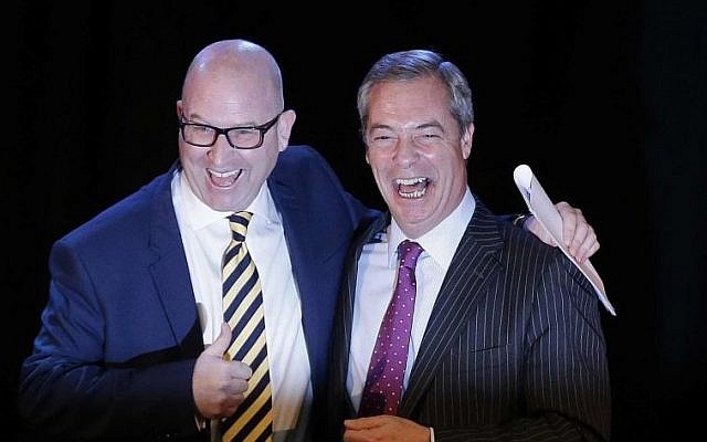 Following the announcement of his new position as leader of the UK Independence Party Paul Nuttall, left, smiles as he is greeted by former leader Nigel Farage at a press conference, London November 28, 2016. (AP/Alastair Grant)
