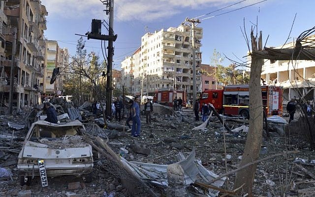 People watch the damage after an explosion in southeastern Turkish city of Diyarbakir, early Friday, Nov. 4, 2016. The cause of the explosion was not immediately known but Hurriyet newspaper said it may have been caused by a car bomb. (IHA via AP) People watch the damage after an explosion in southeastern Turkish city of Diyarbakir, early Friday, Nov. 4, 2016. The cause of the explosion was not immediately known but Hurriyet newspaper said it may have been caused by a car bomb. (IHA via AP)