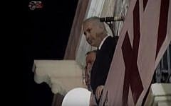 Then opposition leader Benjamin Netanyahu looks out over a right-wing rally in Jerusalem's Zion Square in 1995. The slogan on the sign partially visible below him reads: 'The nation did not decide.' (screen capture: YouTube)