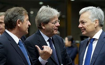 Italian Foreign Minister Paolo Gentiloni, center, speaks with Belgian Foreign Minister Didier Reynders, right, and Slovenian Foreign Minister Karl Erjavec, left, during a meeting of EU foreign ministers at the EU Council building in Brussels on Monday, Nov. 14, 2016. (AP Photo/Virginia Mayo)