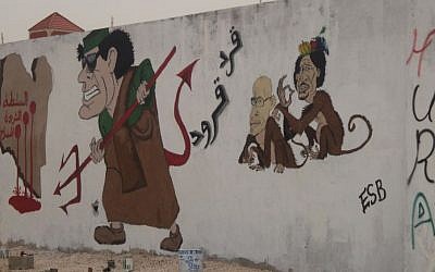 Caricatures of former Libyan dictator Muammar Gaddafi and his son as monkeys in Benghazi, Libya. (Wikimedia Commons)