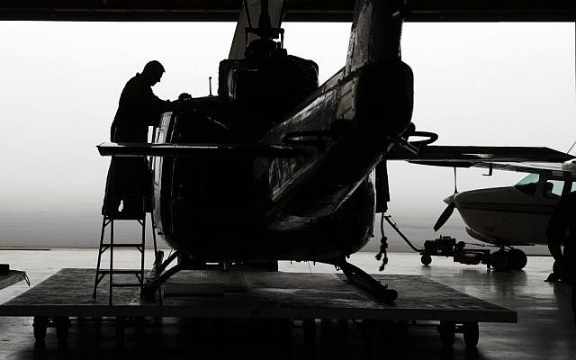 In this Tuesday, Nov. 15, 2016, photo, U.S. Air and Marine prepare a Huey for a mission to search for immigrants who entered the county illegally, in McAllen, Texas. (AP Photo/Eric Gay)