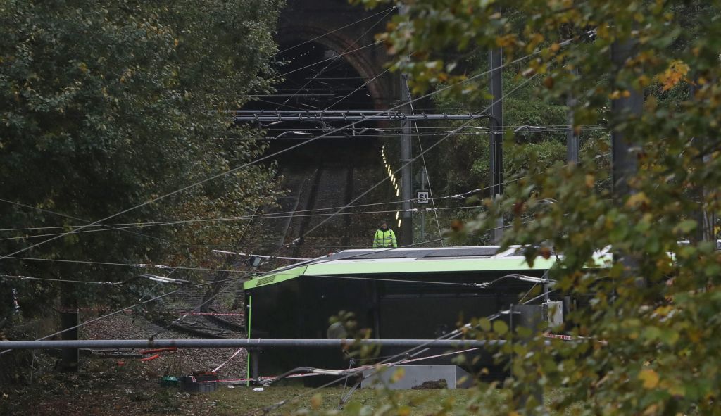An emergency services worker looks at a derailed tram in Croydon, south London, November 9, 2016. (Steve Parsons/PA via AP) An emergency services worker looks at a derailed tram in Croydon, south London, November 9, 2016. (Steve Parsons/PA via AP)