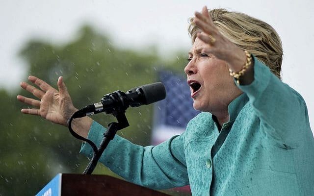 Democratic presidential candidate Hillary Clinton speaks during a heavy rain at a rally at C.B. Smith Park in Pembroke Pines, Fla., Saturday, Nov. 5, 2016. (AP Photo/Andrew Harnik) 
