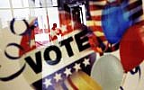 In this November 1, 2016, photo, a voter is reflected in the glass frame of a poster while leaving a polling site in Atlanta, during early voting ahead of the Nov. 8 election day. (AP Photo/David Goldman)