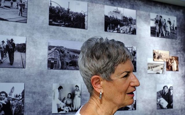 Nechema Friedman, 69, who was born at the hospital stands next to photos of that period in the British military camp, at the Cypriot military camp in capital Nicosia, on Wednesday, Nov. 9, 2016. (AP Photo/Petros Karadjias)