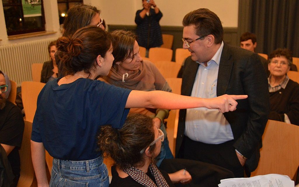 The subjects of a violent altercation at the meeting. The man in the suit attacked the women, who were pro-Israel. The women were asked to leave. (Felix Balandat/Times of Israel) The subjects of a violent altercation at the meeting. The man in the suit attacked the women, who were pro-Israel. The women were asked to leave. (Felix Balandat/Times of Israel)
