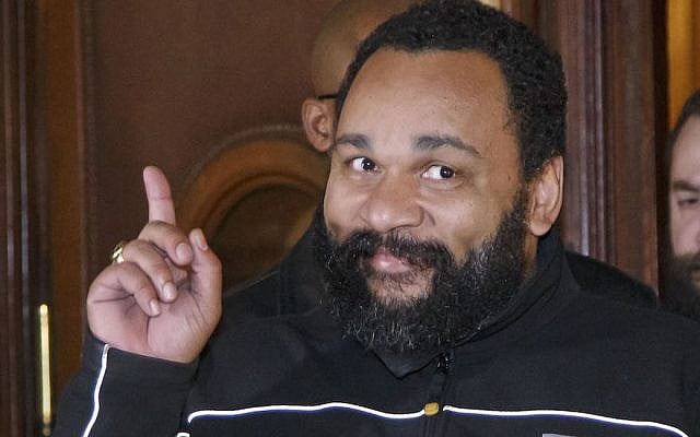 French comedian Dieudonne M’Bala M’Bala gesturing to the media as he leaves a Paris court house, February 4, 2015. (Michel Euler/AP Images/via JTA French comedian Dieudonne M’Bala M’Bala gesturing to the media as he leaves a Paris court house, February 4, 2015. (Michel Euler/AP Images/via JTA