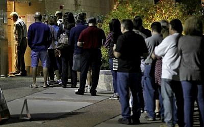 Voters wait in line to vote early Tuesday, Nov. 8, 2016, in Phoenix, Arizona. (AP Photo/Matt York)