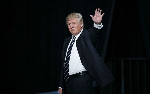 Republican presidential candidate Donald Trump waves to the audience exiting a campaign rally in Grand Rapids, Michigan, Tuesday, Nov. 8, 2016. (AP Photo/Paul Sancya)