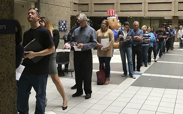 The line of voters waiting to cast an early ballot at the Santa Clara County Registrar of Voters' office winds into the building's atrium Monday, Nov. 7, 2016, in San Jose, California. (Ramman Kenoun/Santa Clara Country Registrar of Voters via AP)