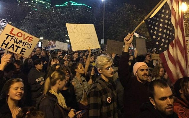 Protesters march on their way to Waterfront Park in Portland, Oregon, on the third day of protests over the results of the 2016 US presidential election, Thursday, Nov. 10, 2016. (Jim Ryan/The Oregonian via AP)
