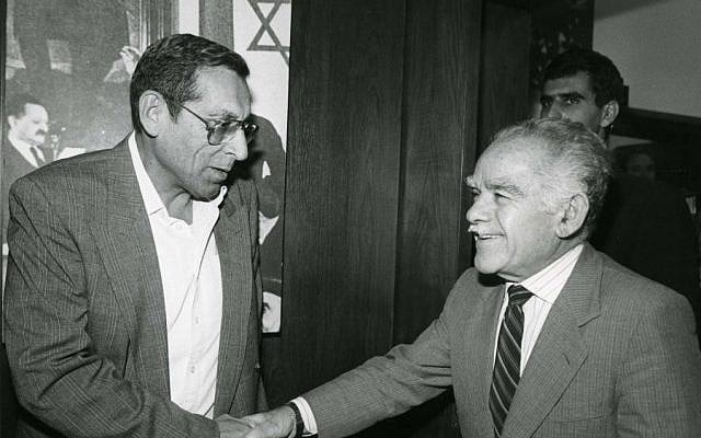 AN undated photo of Rehavam Zeevi shaking hands with former prime minister Yizhak Shamir. (Moshe Shai/Flash90)