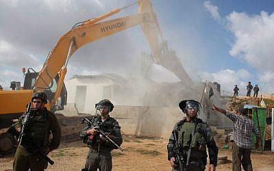 Illustrative photo of Israeli troops standing near a tractor demolishing a Palestinian structure in the East Jerusalem neighborhood of Beit Hanina, November 24, 2011. (Issam Rimawi/FLASH90) 