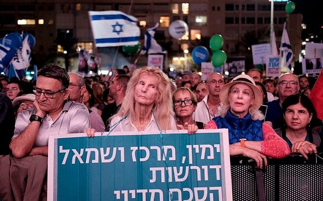 Israelis attend a rally marking 21 years since the assassination of Yitzhak Rabin at Rabin Square in Tel Aviv on November 5, 2016. The banner reads: 'Right, center and left demand a diplomatic agreement' (Photo by Tomer Neuberg/Flash90)