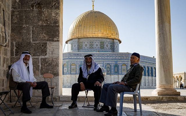 Three Arab men in front the Dome of the Rock seen on the al-Aqsa Mosque compound in the Old City of Jerusalem, on November 08, 2016. (Sebi Berens/Flash90)