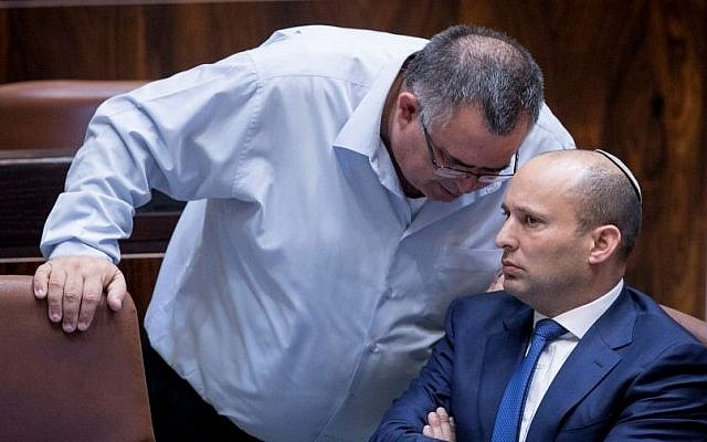 Jewish Home leader Naftali Bennett (R) with MK David Bitan during a plenum session on the so-called Regulation Bill, in the Israeli parliament on November 16, 2016. (Yonatan Sindel/Flash90)