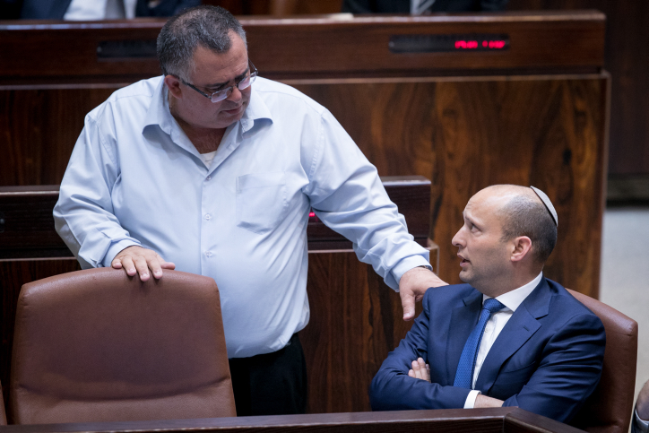 Jewish Home leader Naftali Bennett (R) with MK David Bitan during a plenum session on the so-called Regulation Bil on November 16, 2016. (Yonatan Sindel/Flash90) Jewish Home leader Naftali Bennett (R) with MK David Bitan during a plenum session on the so-called Regulation Bil on November 16, 2016. (Yonatan Sindel/Flash90)