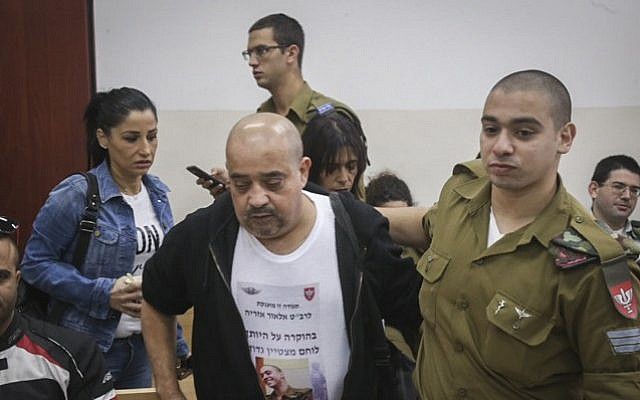 Elior Azaria seen with his father, left, during a court hearing at a military court in Jaffa, November 23, 2016. (Flash90) Elior Azaria seen with his father, left, during a court hearing at a military court in Jaffa, November 23, 2016. (Flash90)