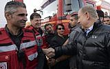 Prime Minister Benjamin Netanyahu speaks with Israeli firefighters during his visit at the fire command post in Zichron Yaakov, November 23, 2016. (Haim Zach / GPO)