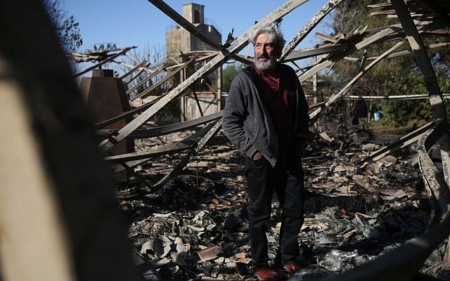 An Israeli artist stands in his studio, burned in an overnight fire in Beit Meir, outside of Jerusalem on November 25, 2016. (Hadas Parush/Flash90) An Israeli artist stands in his studio, burned in an overnight fire in Beit Meir, outside of Jerusalem on November 25, 2016. (Hadas Parush/Flash90)