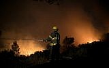 Illustrative: Firefighters battle a wildfire near Nataf, outside of Jerusalem, on November 25, 2016. (Yonatan Sindel/Flash90)