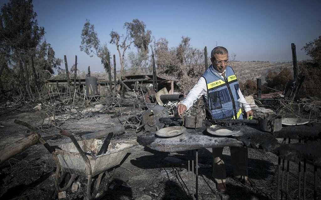 A state official inspects the damage at the remains of Nafat restuarant Rama's Kitchen following a wildfire, on November 28, 2016. (Photo by Yonatan Sindel/Flash90)