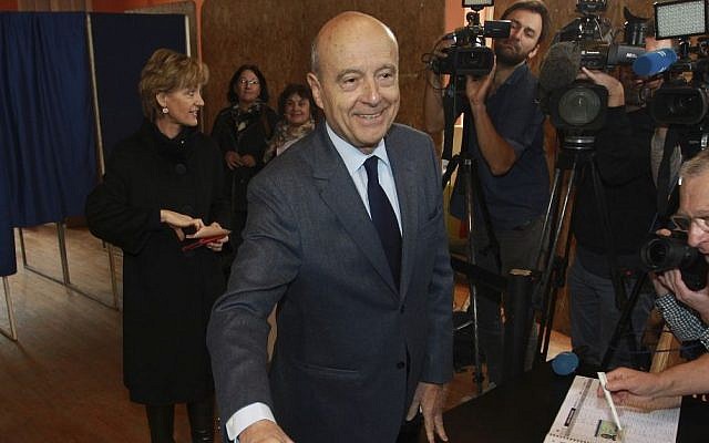 Former prime minister and Bordeaux's mayor Alain Juppe, a candidate for France's upcoming presidential primary election, casts his vote for the conservative primary election in Bordeaux, southwestern France, November 20, 2016. (AP Photo/Bob Edme)