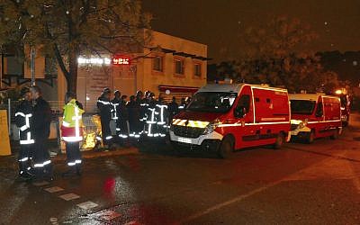 Firefighters and ambulances are seen in the village of Montferrier-sur-Lez, southern France, Friday, Nov. 25, 2016. The French gendarmerie says a masked gunman burst into a retirement home for monks and killed an elderly woman with a knife there. (AP Photo)