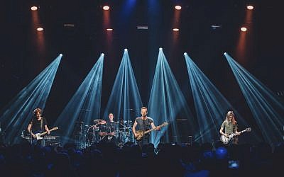 In this Saturday, November 12, 2016 photo provided by Universal Music France, British musician Sting, center, performs on stage at the reopened Bataclan concert hall in Paris, France, Saturday, November 12, 2016. (Boris Allin/Universal Music France via AP) 