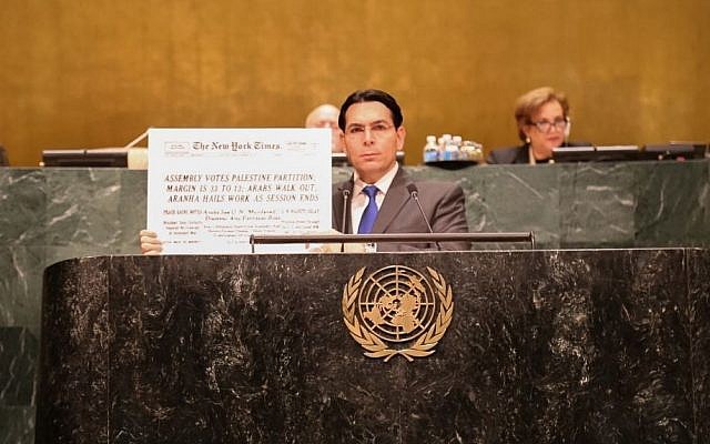 Israeli ambassador to the United Nations, Danny Dannon, holds up a placard bearing a copy of the front page of the New York Times from November 30, 1949 with the headline: Assembly Votes Palestine Partition, Arabs Walk Out… Disavow Any Partition Role. Courtesy)
