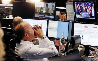 A broker reacts as new elected US President Donald Trump shows up on a television screen at the stock market in Frankfurt, Germany, Wednesday, Nov. 9, 2016. (AP Photo/Michael Probst)