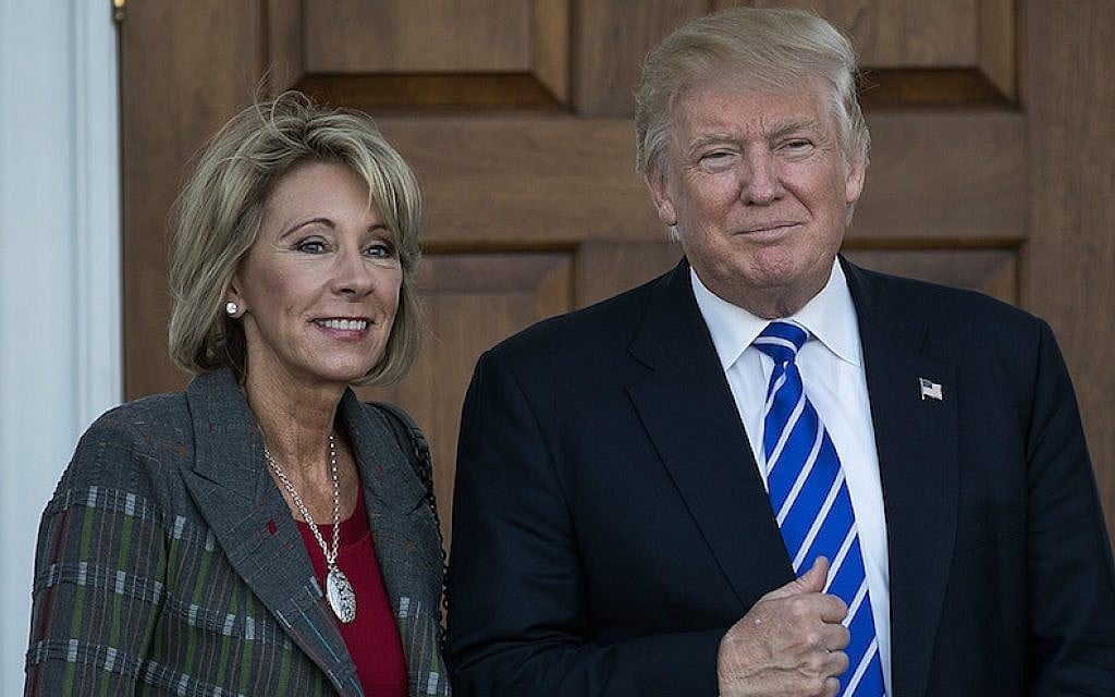 Betsy DeVos and President-elect Donald Trump outside the clubhouse at Trump International Golf Club in Bedminster Township, New Jersey, Nov. 19, 2016. (Drew Angerer/Getty Images via JTA) Betsy DeVos and President-elect Donald Trump outside the clubhouse at Trump International Golf Club in Bedminster Township, New Jersey, Nov. 19, 2016. (Drew Angerer/Getty Images via JTA)