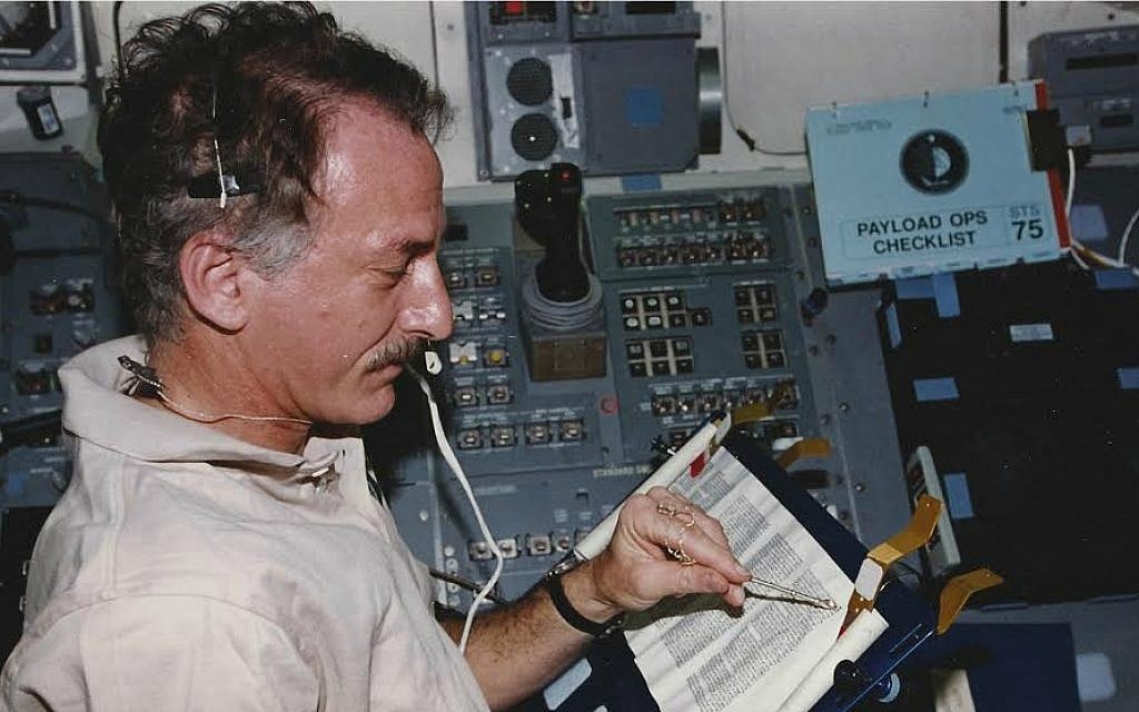 Jeffrey Hoffman reads from the Torah aboard the space shuttle Columbia during a 1996 mission. (Courtesy of Hoffman) Jeffrey Hoffman reads from the Torah aboard the space shuttle Columbia during a 1996 mission. (Courtesy of Hoffman)
